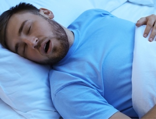 Man sleeping with sleep apnea