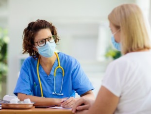 Doctor talking to patient with mask