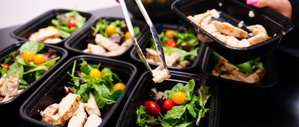 Man puts label on a prepared meal