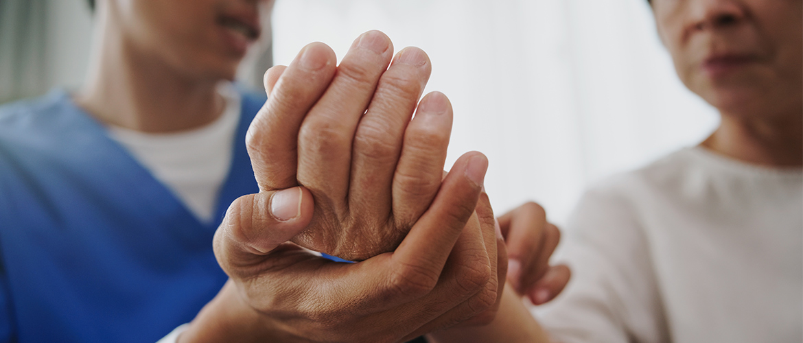 Health care provider holds a woman's hands