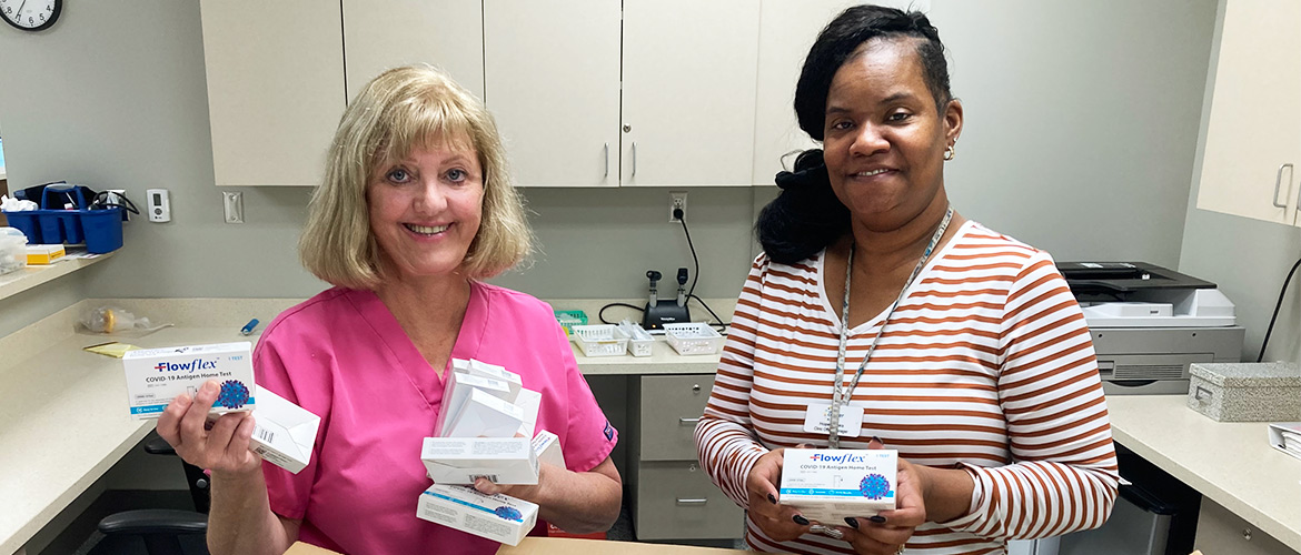 Women in health clinic unpack COVID-19 testing kits