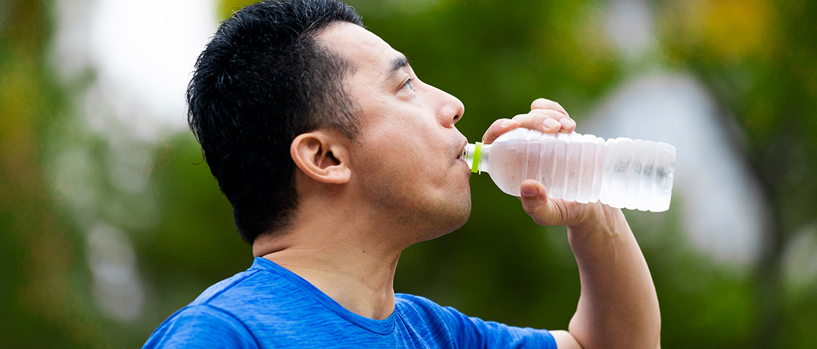 Man drinks a bottle of water