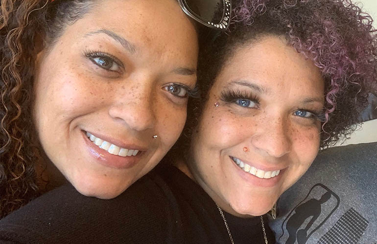 Twin sisters who work for Blue Cross and Blue Shield of Oklahoma smile for a selfie 