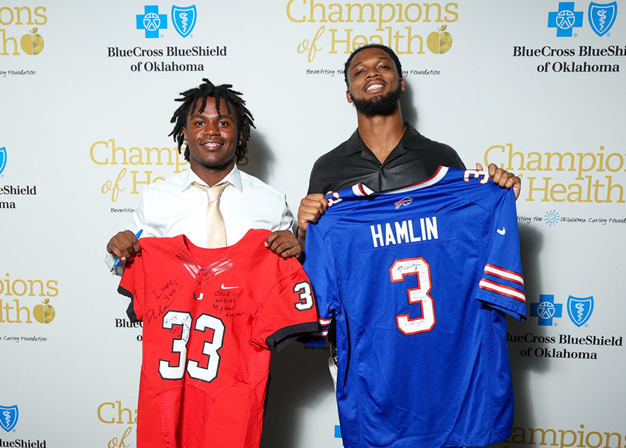 Two football players swap jerseys