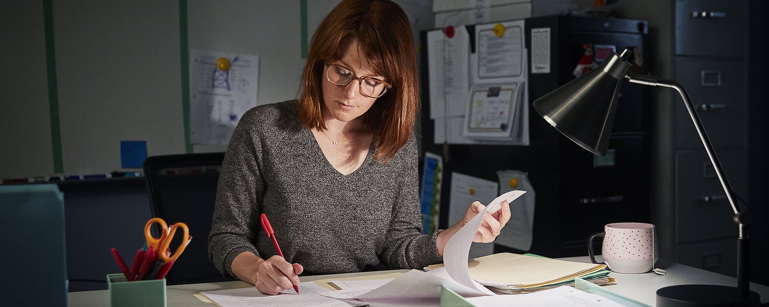 Woman working on paperwork at desk