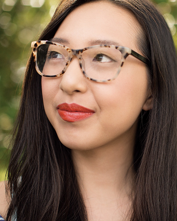 Woman wearing glasses gazes into distance