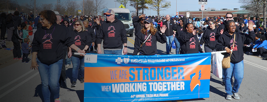 BCBSOK employees walk in MLK parade holding banner