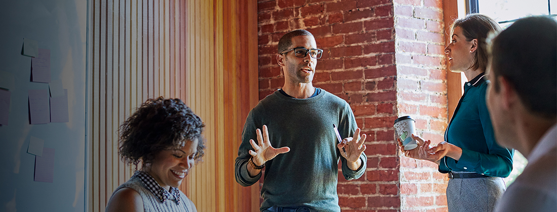 A diverse group of workers collaborate together in office space